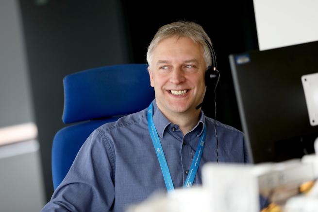 A colleague smiling working at their computer