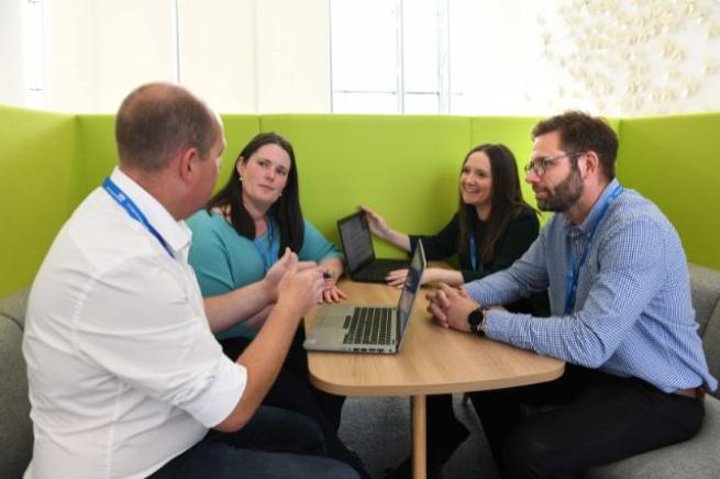 Four colleagues talking