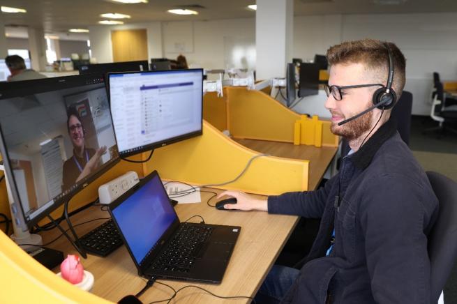 Colleague sitting at a desk wearing a headset