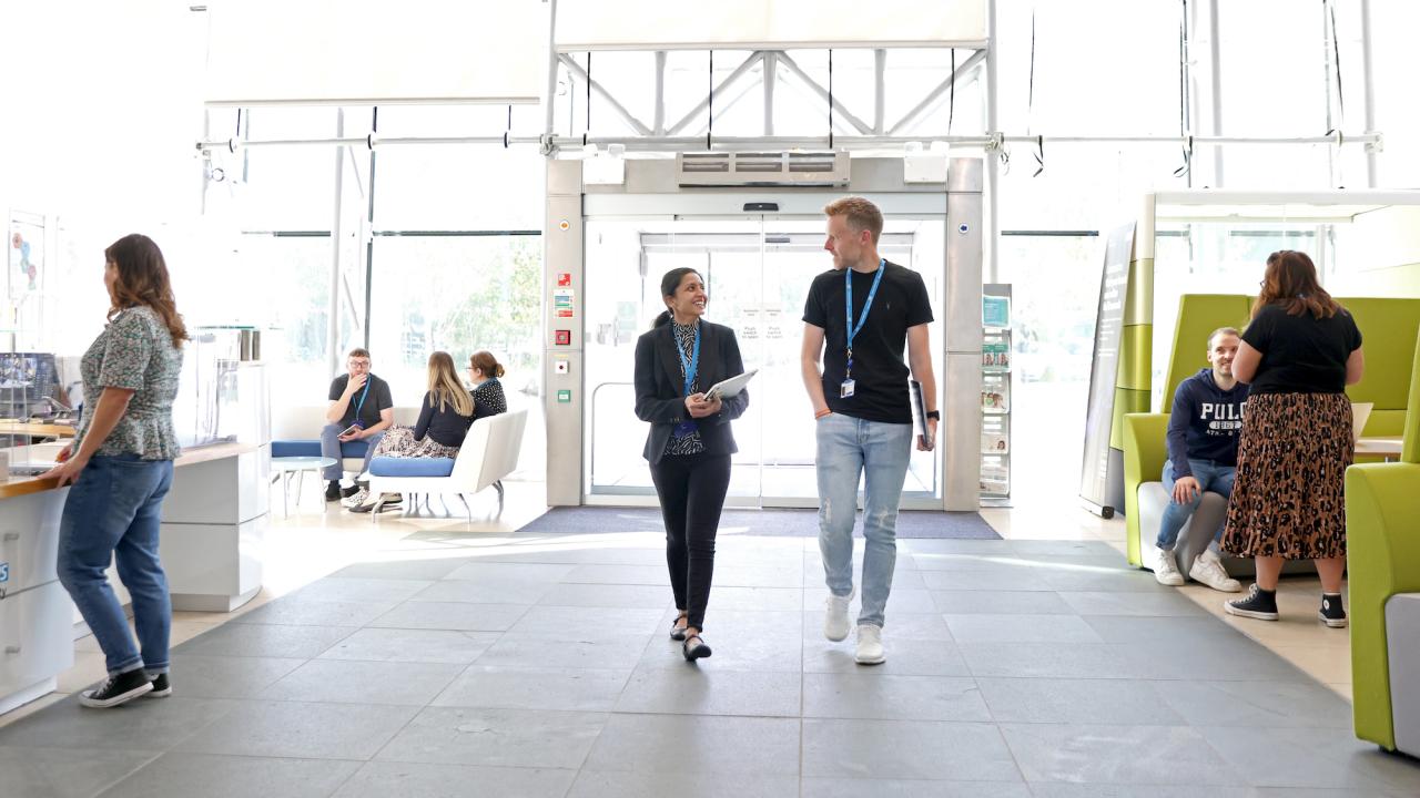 Lobby area of an office building with a man and woman walking in 