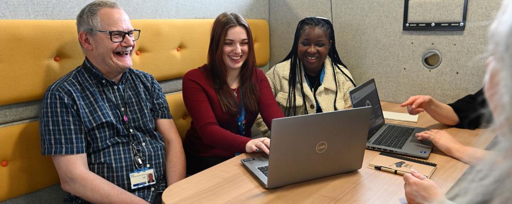 Colleagues sitting together smiling